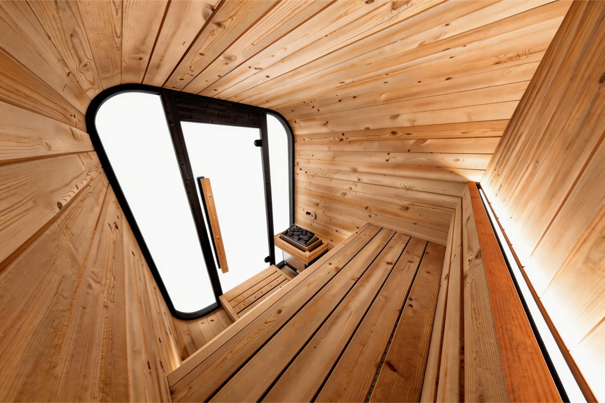 Interior view of Valencia Haven outdoor sauna showing warm wood cabin and glass door